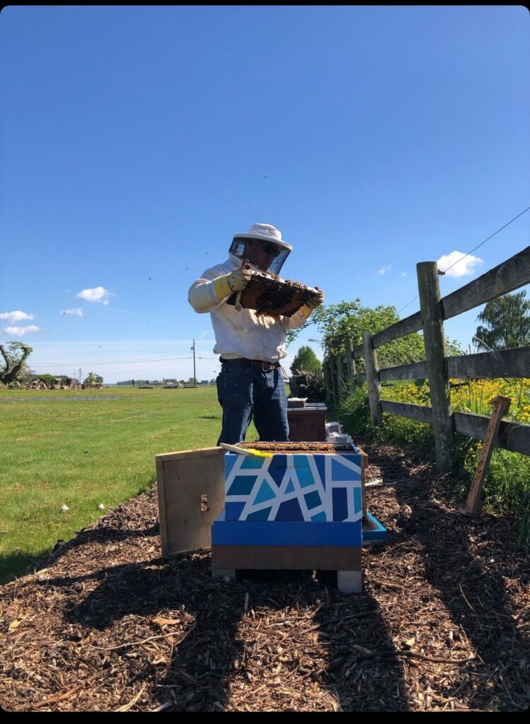 Jeff Brown of Bee Merry Farm enjoys beekeeping on the working farm. Photo by Bee Merry Farm 